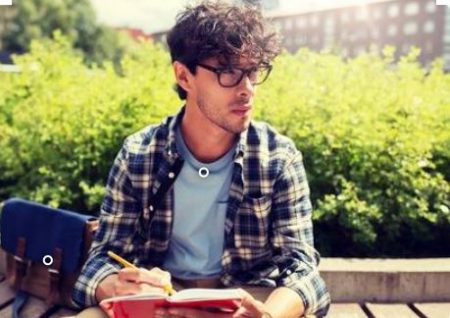 man with notebook or diary writing on city street